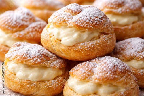 cream puffs stacked with powdered sugar