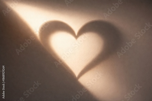 A heart of light and shadow on a flat surface. Love concept and Valentine's Day greetings for social media