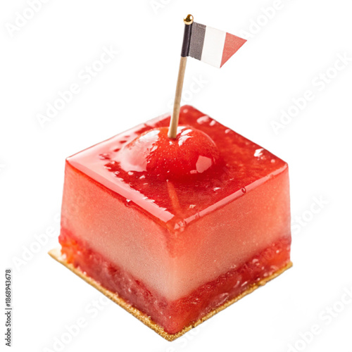 A vibrant gelatin dessert cube with a cherry and flag toothpick, perfect for culinary promotions or dessert showcases