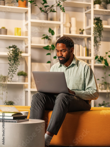 Professional Man Working On Laptop In A Cozy Modern Office 
