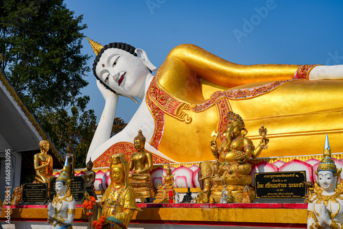 Magnificent giant reclining Buddha statue at Wat Phra That Doi Kham temple on the mountain side of Chiang Mai, Northern Thailand
