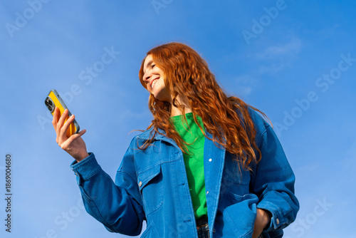Happy woman with phone blue skye