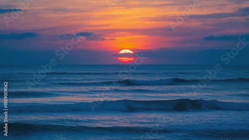 Wallpaper Mural Large orange sun setting over calm ocean water Torontodigital.ca