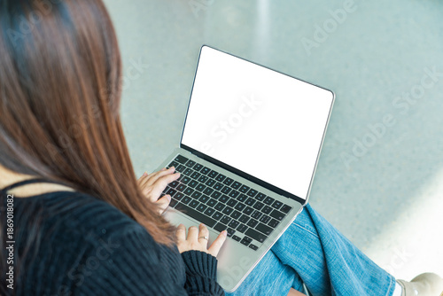Close-up of laptop screen with blank white display in workspace
