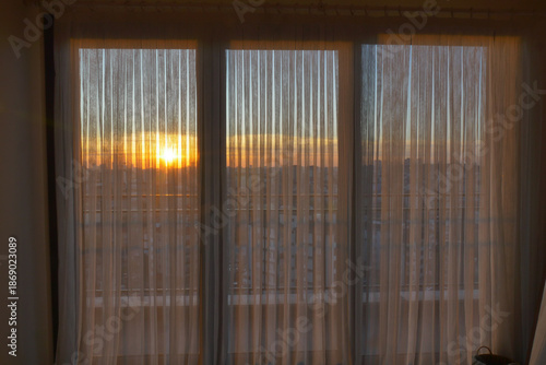 Wallpaper Mural Sunset view through curtains in an urban setting Torontodigital.ca