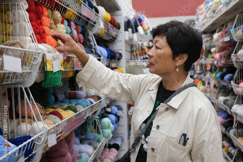 A woman shopping for yarn and crafting supplies in craft store