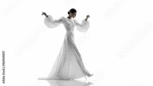 Elegant Woman in Flowing White Dress Posing Gracefully.
