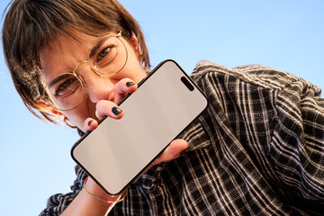 smartphone Held by a Young Woman Against the Sky. For mockup