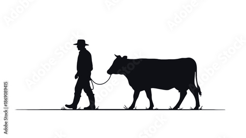 A cowboy walks a cow in a peaceful rural landscape