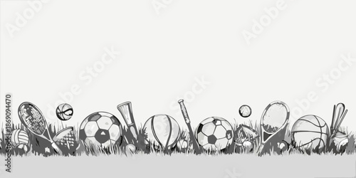 A variety of sports equipment arranged amongst blades of grass