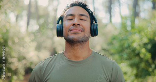 Canvas Print Headphones, peace and health with man in nature for streaming service, meditation sound and calm