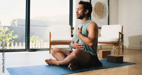 Tableau sur toile Mindfulness, yoga and man in home, breathing and meditation for inner peace, calm or wellness on mat