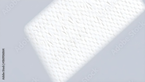 A closeup shot of a soft white watercolor paper texture with a subtle shadow cast across it creating a diagonal line of light and shade with white background