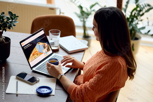 Woman uses laptop at her workplace