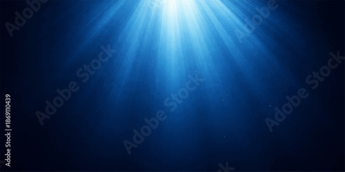 Deep blue underwater world background with sun rays bursting through the surface