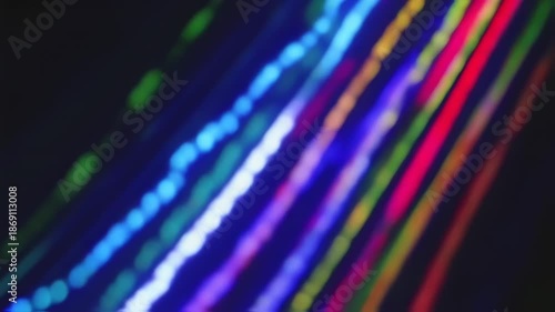 Abstract shot of colorful, blurred light trails against a dark background, creating dynamic streaks