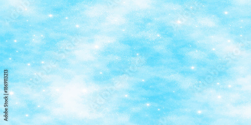 A beautiful abstract blue Christmas background features fluffy white clouds and bright sunlight in a clear summer sky to create a heavenly atmosphere