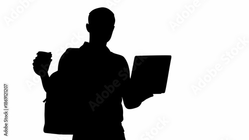 Businessman with laptop and coffee in hand standing confidently