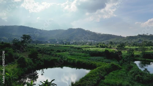 Scenic countryside landscape of Ba Vi with rice terraces and cloudy sky.