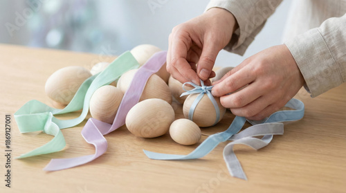 Decorating Easter eggs with colorful ribbons for a festive celebration
