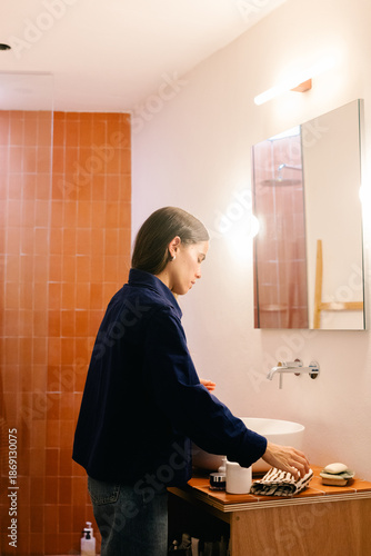 Woman carrying out her morning skincare steps in the bathroom