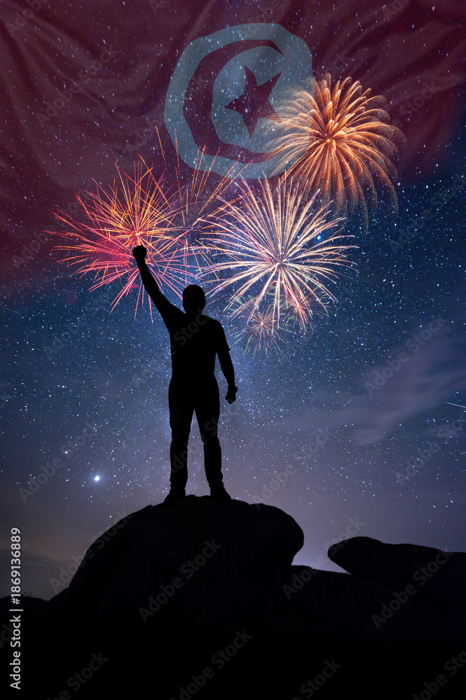 Fototapeta premium Man against background of a fireworks and national flag of Tunisia
