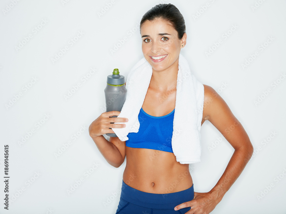 Fototapeta premium Studio, fitness or portrait of woman with bottle of water, training break or post workout hydration. Space, wellness or person smile with drink for health, sweat towel or exercise on white background