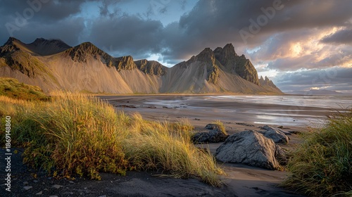 Dramatic view of Stokksnes beach, Iceland, black sand shoreline with Vestrahorn mountain backdrop, moody coastal landscape outdoors