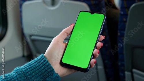 Woman Holding Green Screen Smartphone On Train Journey