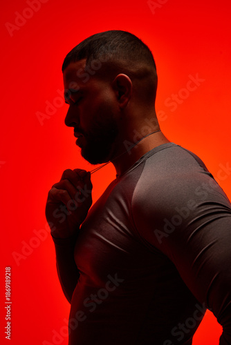 Silhouette of a man against a bold red background during a photo