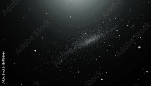 Abstract dark background with shimmering dust particles and light flares creating a cosmic or ethereal atmosphere illuminated by soft spotlights for