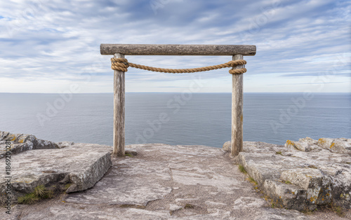 Wallpaper Mural Viewpoint overlooking the ocean with wooden frame near rocky shoreline during cloudy day in coastal area Torontodigital.ca