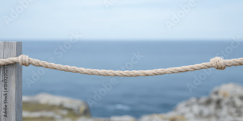 Wallpaper Mural Rope tied to post along coastal area with ocean view in the background during daylight Torontodigital.ca