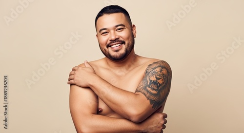Confident Man with Tattoo Posing in Minimal Studio Portrait