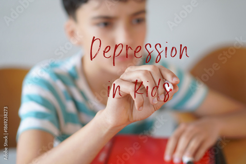 DEPRESSION IN KIDS. Mental health concepts in childhood and adolescence. boy writing text