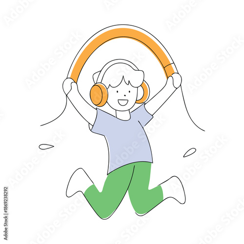 Energetic boy jumping with joy while holding headphones like a jump rope