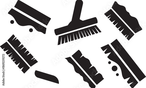 Black and white cleaning brush icons on white background