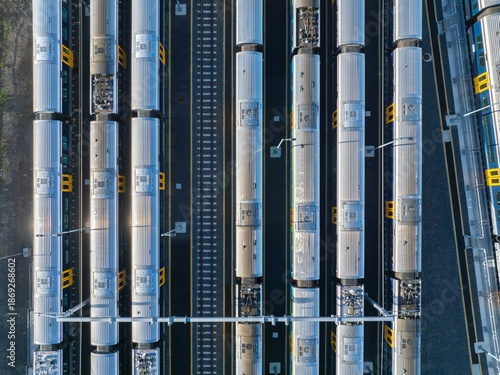 Aerial view of commuter trains parked at a train yard in Auckland, New Zealand. The trains are awaiting their next scheduled departure.