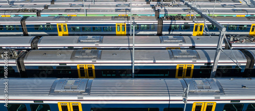 Commuter trains sit idle in a train yard in Auckland, New Zealand. The trains are awaiting their next assignment to transport passengers throughout the city.