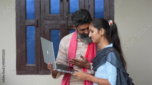farmer using laptop with daughter