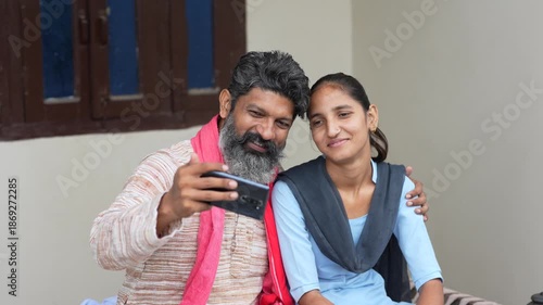 indian farmer using smartphone with daughter