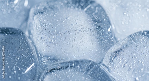 Clear ice cubes with water droplets on surface closeup