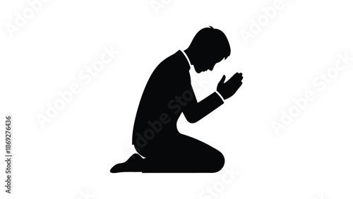 A silhouette of a man kneeling in a pose of prayer or reverence