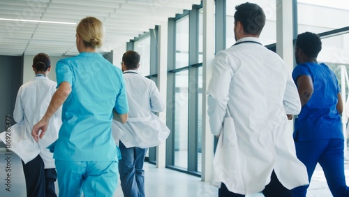 Medical team running through clinic hallway toward emergency operation room. Focused professionals moving quickly showing urgency and coordination. Healthcare staff responding fast.