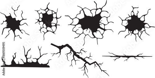 Collection of black jagged crack patterns depicting broken surfaces or shattered impact zones
