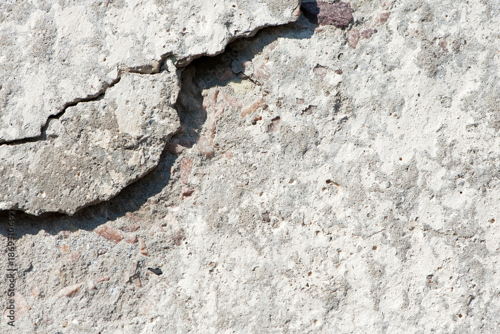 Fototapeta premium old plaster on the wall, cement, adhesive for screed. the old clay wall is crumbling. surface wall for vintage background. Wall texture, cracked plaster, grey cement floor, needs repair, restoration