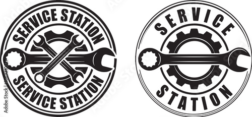 Two circular black and white service station emblems with crossed wrenches and gears