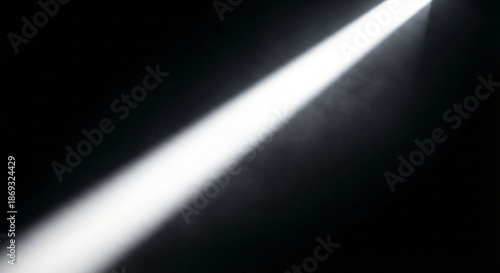 A radiant beam of bright white light piercing through the mysterious darkness