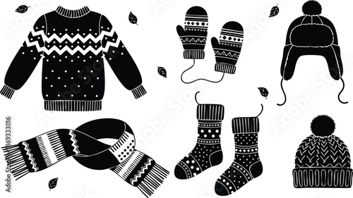Black and white vector art of winter clothes including patterned sweater warm mittens knitted scarf cozy socks and pompom hat with earflaps and isolated decorative leaves
