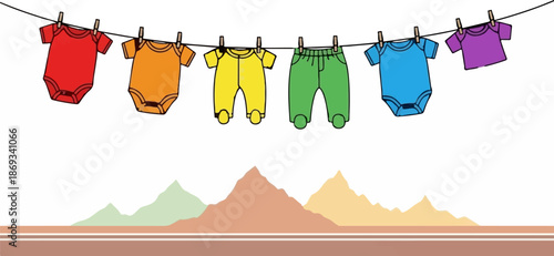 Colorful baby clothes are hanging on a clothesline above a stylized mountain landscape